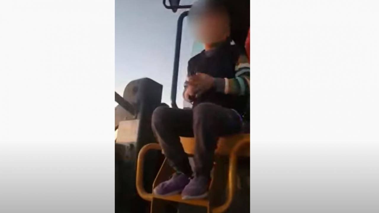 Kazakhstanis discussing video with a child driving a forklift